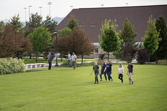 Students gather together to plant flowers on the temple grounds.