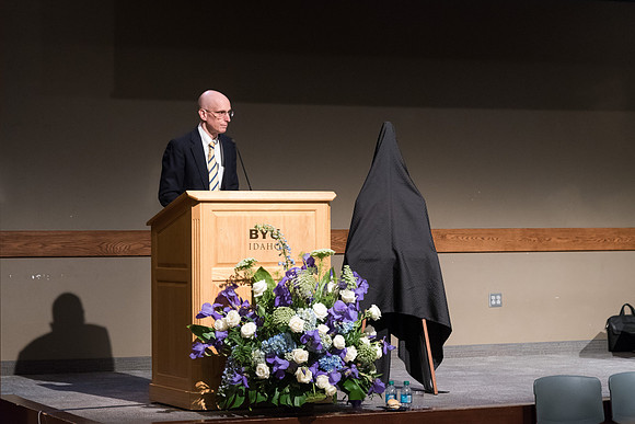 A farewell reception is held for President and Sister Gilbert, and their family. President Eyring presents President Gilbert with a gift. 2017