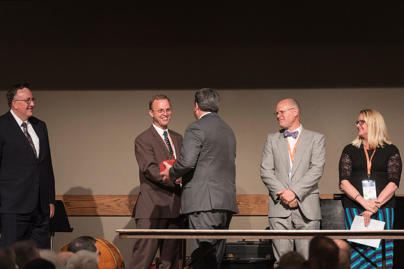 Online Employees gather together for a Banquet and Awards Ceremony for their final evening together.