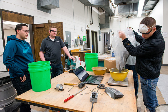 Civil engineering students work with different mixtures of cement to make a light, yet durable, cement that will be the building material for a canoe.