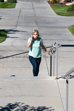 Examples of students staying safe and healthy during the COVID-19 pandemic by social distancing, following pathway arrows, and wearing face masks.