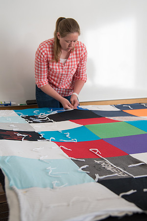 Brother Tyler Watson leads students in the Public Health Major in Quilt Tying.