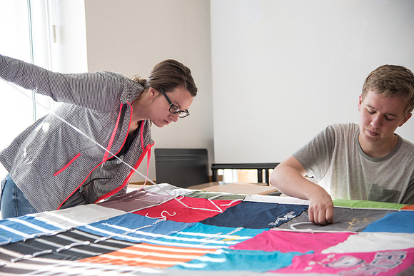 Brother Tyler Watson leads students in the Public Health Major in Quilt Tying.