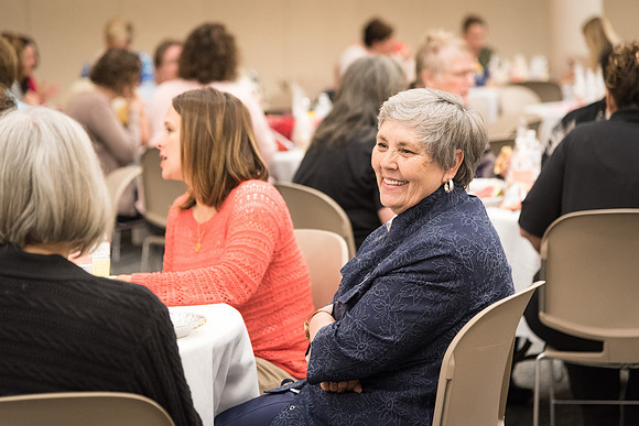 Women employees gather to enjoy lunch together.