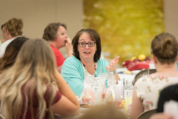 Women employees gather to enjoy lunch together.