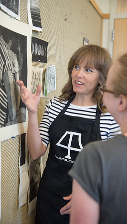 Art professor Carla Jimison speaks with a student about printmaking. 2017