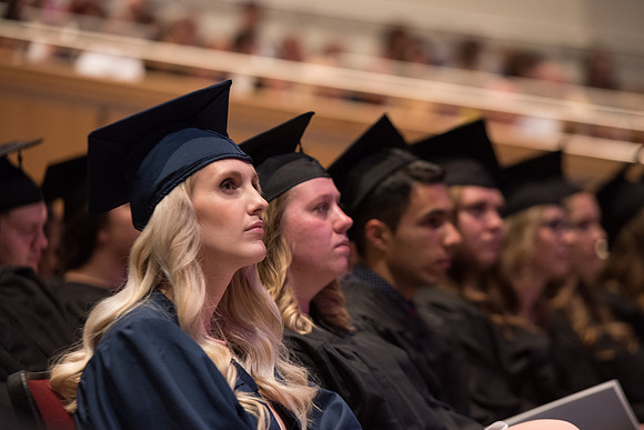 Graduate listens to the speaker during Commencement.