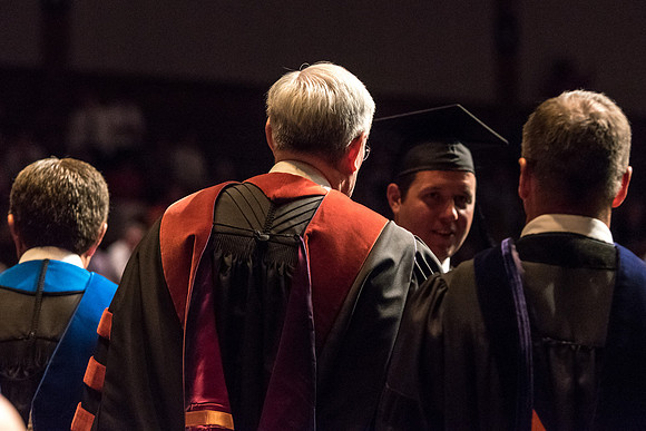 Business and Communications students walk across the stage and receive their diplomas. 2017