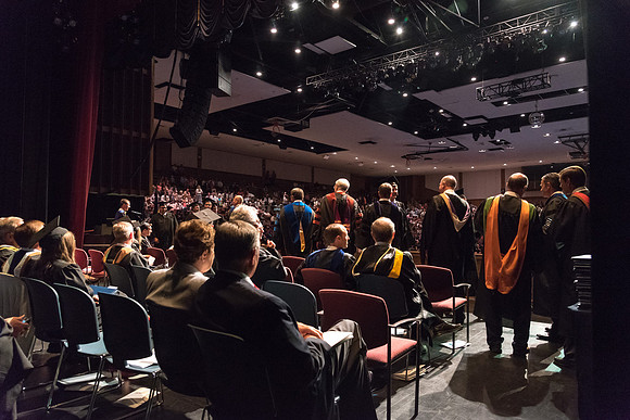 Business and Communications students walk across the stage and receive their diplomas. 2017