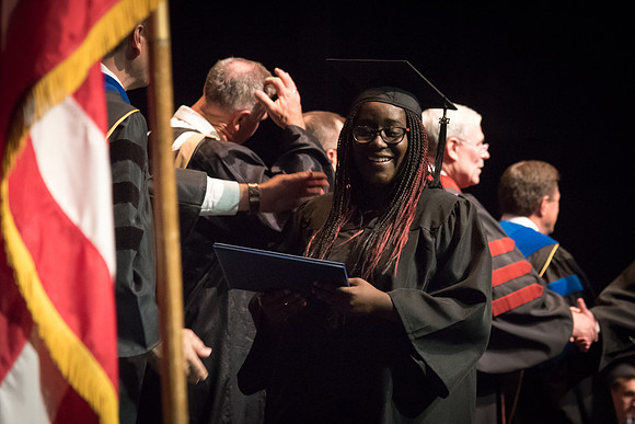 Business and Communications students walk across the stage and receive their diplomas. 2017