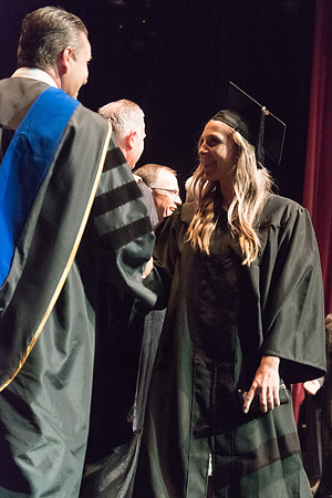 Business and Communications students walk across the stage and receive their diplomas. 2017