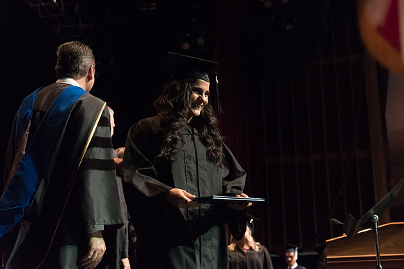 Business and Communications students walk across the stage and receive their diplomas. 2017