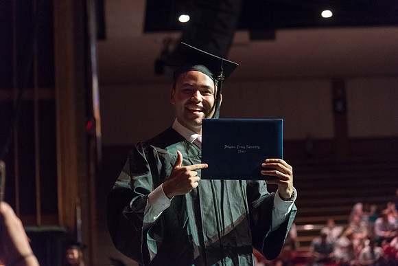 Business and Communications students walk across the stage and receive their diplomas. 2017