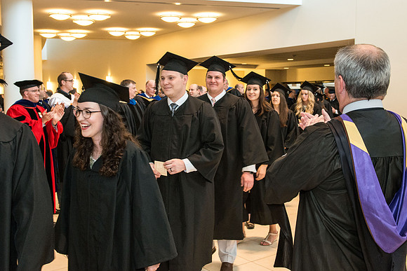 BYU-Idaho Spring semester graduation. Graduates march in during the processional and are congratulated by faculty. July 2017