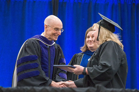 Elder J. Devn Cornish, President Henry J Eyring, and Danae Romrell, Dean of Interdisciplinary Studies, congratulate graduates. Convocation for Foundations and Interdisciplinary Studies graduates. July