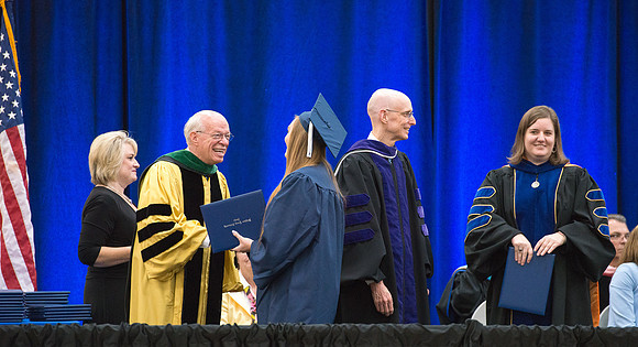 Elder J. Devn Cornish, President Henry J Eyring, and Danae Romrell, Dean of Interdisciplinary Studies, congratulate graduates. Convocation for Foundations and Interdisciplinary Studies graduates. July