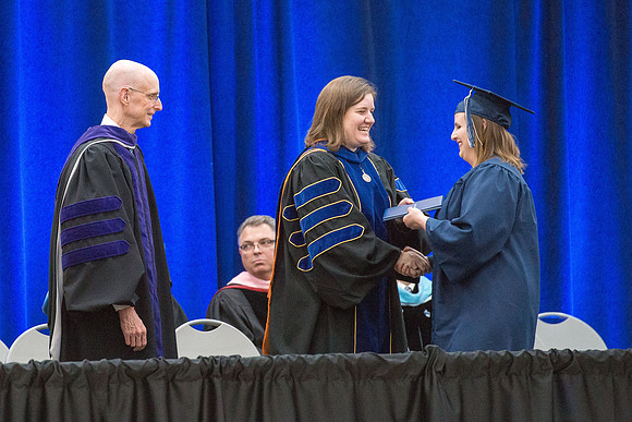 Elder J. Devn Cornish, President Henry J Eyring, and Danae Romrell, Dean of Interdisciplinary Studies, congratulate graduates. Convocation for Foundations and Interdisciplinary Studies graduates. July