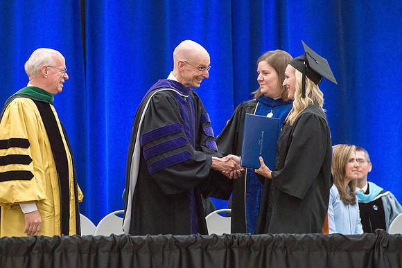 Elder J. Devn Cornish, President Henry J Eyring, and Danae Romrell, Dean of Interdisciplinary Studies, congratulate graduates. Convocation for Foundations and Interdisciplinary Studies graduates. July