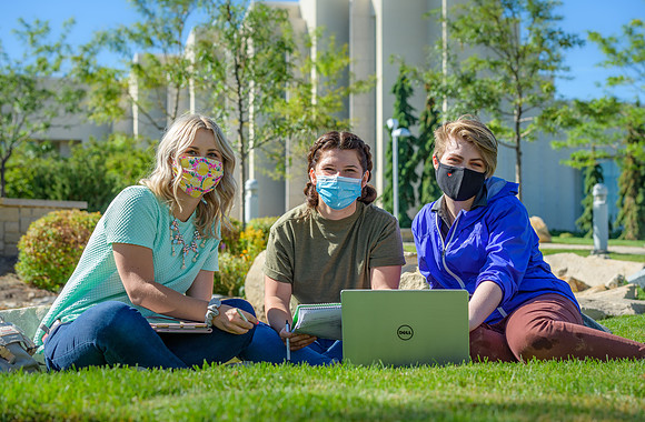 Student volunteers show the way to stay safe during this COVID 19 pandemic by social distancing, following pathway arrows and proper wearing of masks .