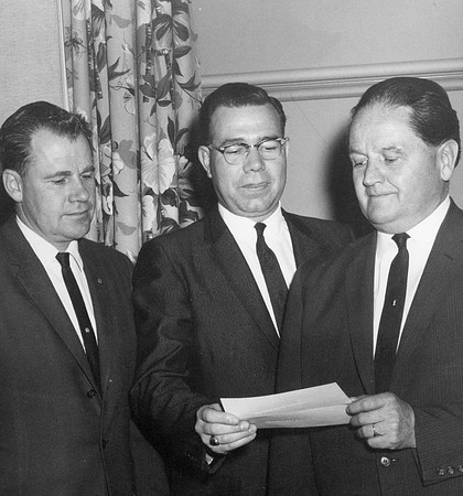 President Clarke receives a donation. John L. Clarke served as President of Ricks College from 1944 to 1971.