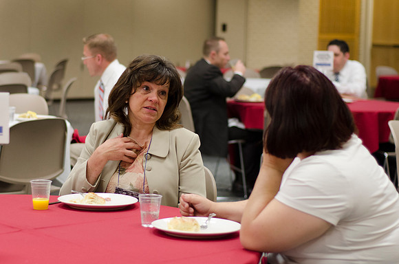 Online instructors gather for breakfast and instruction.
