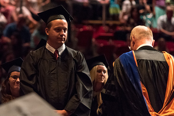 Business and Communications graduates recieve their diplomas at the Spring Convocation. 2017