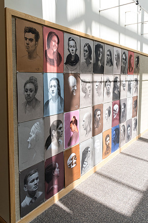 Portraits by students hung in the Spori building.