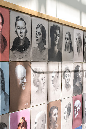 Portraits by students hung in the Spori building.