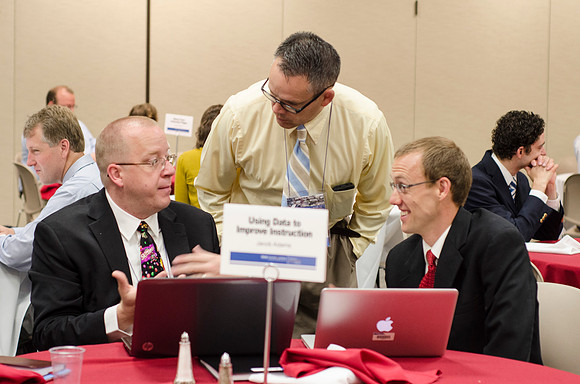 Online instructors gather for breakfast and instruction.
