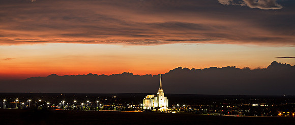 The Rexburg Temple shines brightly against the sunsetting sky.
