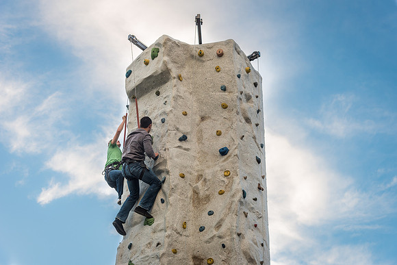 Students make their way up a climbing wall during I Night.