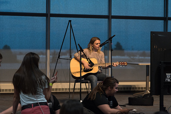 A student performs a song on the Crossroads stage at I-Night.