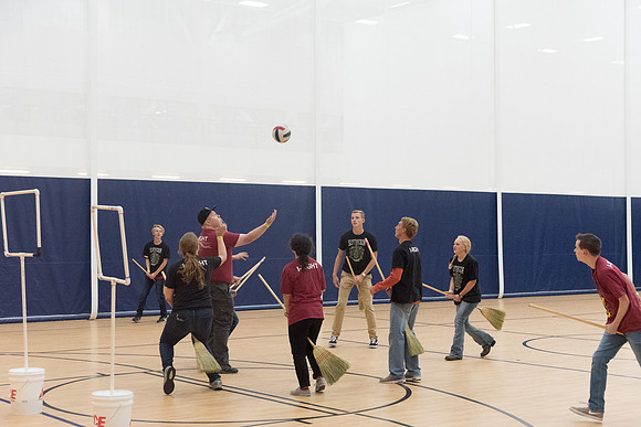 Students play a game of Quidditch, inspired by a sport from Harry Potter.