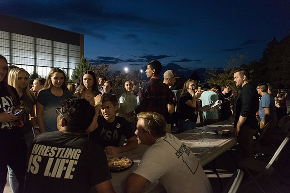 Students participate in a pie eating contest. Each pie is to be eaten by a team of three students who can only use their mouths to eat pies.