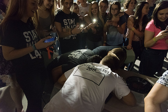 Students participate in a pie eating contest. Each pie is to be eaten by a team of three students who can only use their mouths to eat pies.