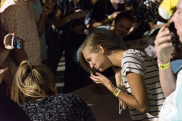 Students participate in a pie eating contest. Each pie is to be eaten by a team of three students who can only use their mouths to eat pies.