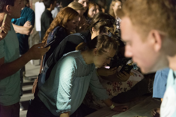 Students participate in a pie eating contest. Each pie is to be eaten by a team of three students who can only use their mouths to eat pies.