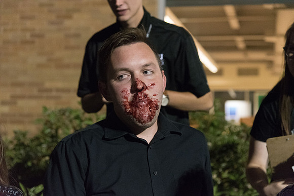 Students participate in a pie eating contest. Each pie is to be eaten by a team of three students who can only use their mouths to eat pies.