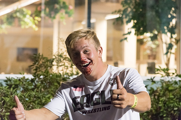 Students participate in a pie eating contest. Each pie is to be eaten by a team of three students who can only use their mouths to eat pies.