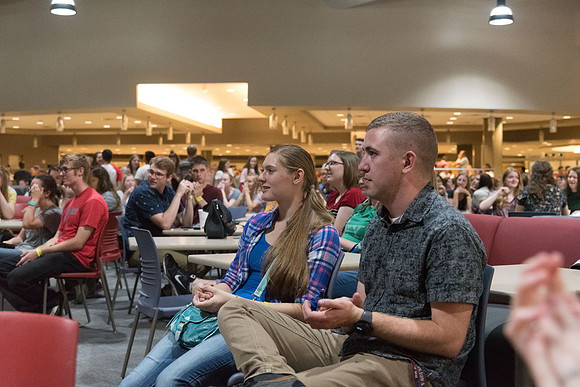 Students cheer for their friends and other who perform on the stage in the Crossroads.