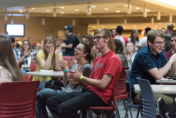 Students cheer for their friends and other who perform on the stage in the Crossroads.