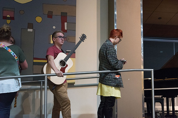 Students stand in line, waiting their turn to perform on the Crossroads stage.