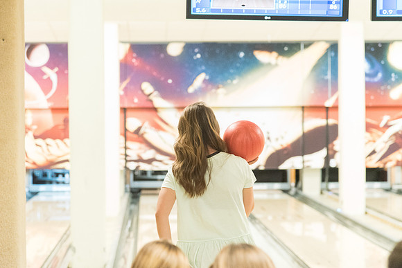 The bowling alley is open during I-Night and students enjoy themselves bowling.