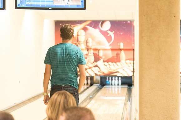 The bowling alley is open during I-Night and students enjoy themselves bowling.
