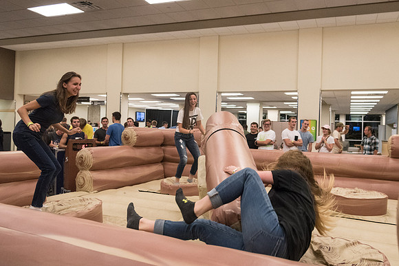 Students stand on inflatable platforms and try not to get knocked over by a spinning arm. They must jump and duck.