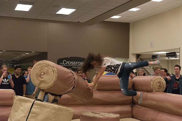 Students stand on inflatable platforms and try not to get knocked over by a spinning arm. They must jump and duck.