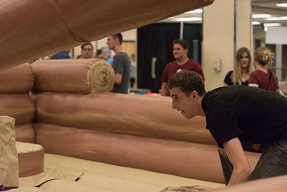 Students stand on inflatable platforms and try not to get knocked over by a spinning arm. They must jump and duck.