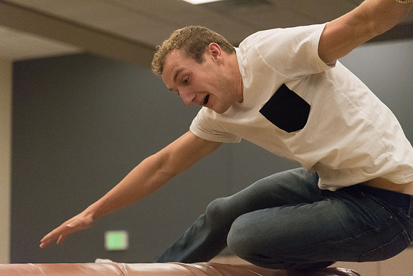 Students stand on inflatable platforms and try not to get knocked over by a spinning arm. They must jump and duck.