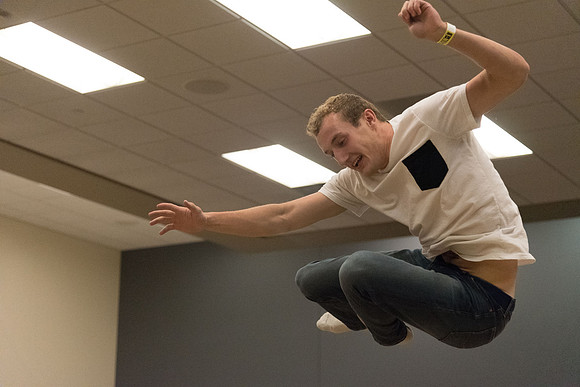 Students stand on inflatable platforms and try not to get knocked over by a spinning arm. They must jump and duck.