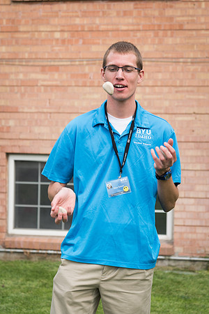 A Student Support volunteer juggles rocks while welcoming new students. 2017